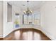 Bright breakfast nook featuring hardwood floors, large windows and a stylish chandelier at 2257 Tatton Hall Rd, Fort Mill, SC 29715