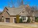 A beautiful home features a two-car garage, brick and stone accents, and manicured landscaping at 2257 Tatton Hall Rd, Fort Mill, SC 29715