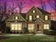 Elegant two-story home with stone and brick exterior under vibrant dusk lighting at 2257 Tatton Hall Rd, Fort Mill, SC 29715