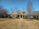 Charming two-story home with a manicured front yard and a classic brick and stone exterior at 2257 Tatton Hall Rd, Fort Mill, SC 29715