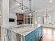 Kitchen island with a marble countertop, modern pendants, and blue cabinets at 2257 Tatton Hall Rd, Fort Mill, SC 29715