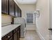 Bright laundry room with counter space, cabinets, and appliances at 2257 Tatton Hall Rd, Fort Mill, SC 29715