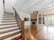 Living room with staircase, stone fireplace and large windows for natural light at 2257 Tatton Hall Rd, Fort Mill, SC 29715