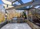 A beautiful outdoor kitchen area with stone countertops, stainless steel grill, and string lights at 2257 Tatton Hall Rd, Fort Mill, SC 29715