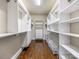 Spacious walk-in closet with custom shelving and hardwood floors at 2257 Tatton Hall Rd, Fort Mill, SC 29715