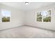 Bright bedroom with two windows and carpet at 328 Shinnville Rd, Mooresville, NC 28115