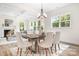 Bright dining room features a wood table with white chairs, hardwood floors and a chandelier at 328 Shinnville Rd, Mooresville, NC 28115