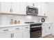 Modern kitchen with black appliances and white cabinets at 328 Shinnville Rd, Mooresville, NC 28115