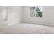 Bedroom with neutral carpet, base trim, natural light from a window, and a closet at 332 Shinnville Rd, Mooresville, NC 28115