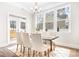 Sunlit dining room with a stylish table, comfortable seating, and scenic views through large windows at 332 Shinnville Rd, Mooresville, NC 28115