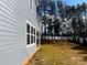 Side view of the home showing the blue siding, white trim, backyard, and new white fence at 332 Shinnville Rd, Mooresville, NC 28115