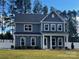 Charming two-story home showcasing a blue exterior, white trim, a welcoming front porch, and well-manicured landscaping at 332 Shinnville Rd, Mooresville, NC 28115