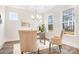 Bright home office with a neutral color palette, desk, two chairs, and ample natural light streaming through the windows at 332 Shinnville Rd, Mooresville, NC 28115