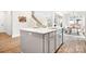 Modern kitchen island with marble countertop, stainless steel sink and faucet, gray cabinets, and adjacent dining area at 332 Shinnville Rd, Mooresville, NC 28115