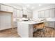 Bright kitchen featuring a spacious island, white cabinets, stainless steel appliances, and a subway tile backsplash at 332 Shinnville Rd, Mooresville, NC 28115