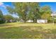 Spacious backyard with large trees and basketball goal at 123 Market Rd, Mooresville, NC 28115