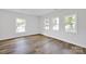 Well-lit bedroom featuring three windows and vinyl flooring at 123 Market Rd, Mooresville, NC 28115