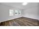 Bright bedroom with three windows and vinyl wood flooring at 123 Market Rd, Mooresville, NC 28115