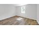 Simple bedroom with a single window and vinyl wood flooring at 123 Market Rd, Mooresville, NC 28115