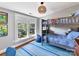 Bedroom featuring a bunk bed, blue rug, and large window at 2110 E 5Th St, Charlotte, NC 28204