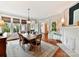 Elegant dining room with hardwood floors, fireplace, and large windows at 2110 E 5Th St, Charlotte, NC 28204