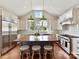 Spacious kitchen featuring white cabinets, a center island, and stainless steel appliances at 2110 E 5Th St, Charlotte, NC 28204