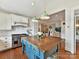 Open kitchen with a large island, pendant lights, and stainless steel appliances at 2110 E 5Th St, Charlotte, NC 28204