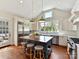 Bright, airy kitchen with island seating, white cabinetry, and stainless appliances at 2110 E 5Th St, Charlotte, NC 28204