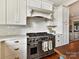 Gourmet kitchen with stainless steel range, oven, and stylish white cabinetry at 2110 E 5Th St, Charlotte, NC 28204