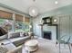 Inviting living room featuring a brick fireplace, modern lighting, and large windows offering natural light at 2110 E 5Th St, Charlotte, NC 28204