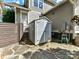 Gray backyard storage shed with double doors with stone pavers at 2110 E 5Th St, Charlotte, NC 28204