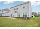 View of the home's backyard with a well-maintained lawn and concrete patio space at 4233 Poplin Grove Dr, Indian Trail, NC 28079