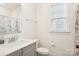 A bathroom with a shower and grey cabinets at 4233 Poplin Grove Dr, Indian Trail, NC 28079