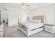 Cozy bedroom with ceiling fan, tray ceiling, and a view to the en suite bathroom at 4233 Poplin Grove Dr, Indian Trail, NC 28079