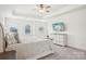 Sunny bedroom with large windows, ceiling fan, and light gray walls at 4233 Poplin Grove Dr, Indian Trail, NC 28079