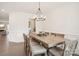 This is a dining room with a chandelier, with hardwood floors and wainscoting at 4233 Poplin Grove Dr, Indian Trail, NC 28079