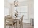 This is a dining room with hardwood floors and a modern chandelier at 4233 Poplin Grove Dr, Indian Trail, NC 28079