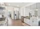 This is a kitchen that leads into a living room area with stainless steel appliances and white cabinets at 4233 Poplin Grove Dr, Indian Trail, NC 28079