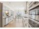 Open-concept kitchen showcases stainless appliances, white cabinetry, granite counters and a view into the dining area at 4233 Poplin Grove Dr, Indian Trail, NC 28079