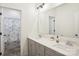 Bathroom featuring double vanity with gray cabinets and a shower with curtain at 4233 Poplin Grove Dr, Indian Trail, NC 28079