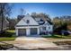 Two-story house with gray double garage doors and a front porch at 409 19Th Avenue Nw Cir # 12, Hickory, NC 28601