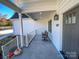 Front porch with gray door and two wicker chairs at 409 19Th Avenue Nw Cir # 12, Hickory, NC 28601