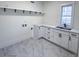 Bright laundry room with white cabinets and a quartz countertop at 409 19Th Avenue Nw Cir # 12, Hickory, NC 28601