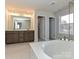 Luxury bath with double sinks, separate shower, and a free standing soaking tub at 8021 Franklin Trail St, Mint Hill, NC 28227