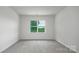 Bright bedroom with large window and grey carpeting at 225 Brinkley Rd # 99, Kings Mountain, NC 28086