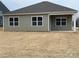 Exterior view of the home's back, highlighting the siding and covered patio at 225 Brinkley Rd # 99, Kings Mountain, NC 28086