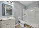 Well-lit bathroom with a single sink vanity, toilet, and shower with modern fixtures at 337 Friendship Dr, Rock Hill, SC 29730