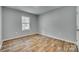 Light-filled bedroom with a view of the outdoors through a window, enhanced by wood-look flooring at 337 Friendship Dr, Rock Hill, SC 29730