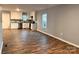 Open living area with light grey walls, wood-look flooring, and a glimpse of the kitchen at 337 Friendship Dr, Rock Hill, SC 29730