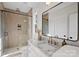 Modern bathroom with a glass-enclosed shower, marble countertop, and gold hardware at 5022 Ohm Ln, Charlotte, NC 28270